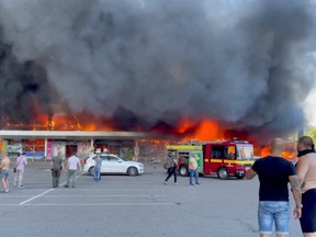 Smoke rises from a shopping mall hit by a Russian missile strike, as Russia's attack on Ukraine continues, in Kremenchuk, Ukraine, June 27, 2022.