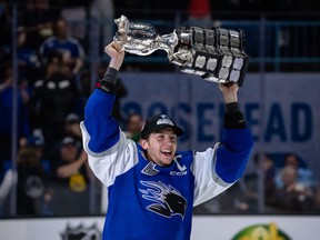 Saint John Sea Dogs captain Vincent Sevigny lifts the Memorial Cup trophy after a 6-3 win against the Hamilton Bulldogs in the final at Harbour Station arena in Saint John, NB, on June 29, 2022.