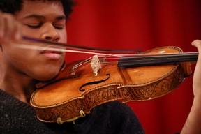 Violinist Braimah Kanneh-Mason plays the rare ‘Hellier’ violin, created by Italian luthier Antonio Stradivari in 1679, which will be offered in the Exceptional Sale at Christie’s auction house in London, Britain, May 30, 2022. REUTERS/Henry Nicholls