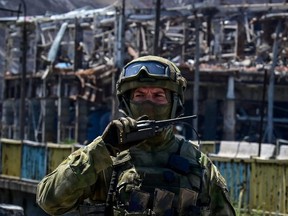 A Russian serviceman patrols near the Azovstal steel plant in Mariupol, amid the ongoing Russian military action in Ukraine, Monday, June 13, 2022.
