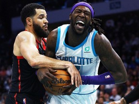 Charlotte Hornets’ Montrezl Harrell reacts as Toronto Raptors’ Fred VanVleet tries to grab the ball in the third quarter Friday at Spectrum Center in Charlotte, N.C., Feb. 25, 2022.