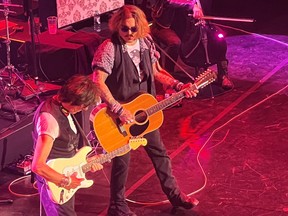 Actor Johnny Depp joins musician Jeff Beck on stage during a concert, in Gateshead, Britain June 2, 2022 in this picture obtained by Reuters from social media.