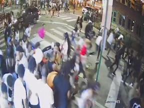 A screen grab from a surveillance video from the shooting shows people on a crowded street running in panic, presumably after gun shots were fired, in Philadelphia, Pa., June 4, 2022.