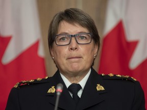 RCMP Commissioner Brenda Lucki listens to a question during a news conference in Ottawa, Wednesday October 21, 2020. THE CANADIAN PRESS/Adrian Wyld