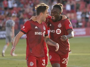 Toronto FC forward Ayo Akinola (20) celebrates scoring against CF Montreal with Toronto FC midfielder Luca Petrasso (38) during the first half at BMO Field on Wednesday night.
