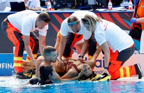 Anita Alvarez of the U.S. receives medical attention during the women’s solo free final in Budapest on June 22, 2022. REUTERS/Lisa Leutner