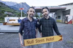 Swiss artists Frank and Patrik Riklin pose next to the anti-idyllic suite of the Null-Stern-Hotel (Zero-Star-Hotel), offering guests a choice between four open-air rooms in reaction to the world current state after the pandemic, in Saillon, Switzerland, June 14, 2022.