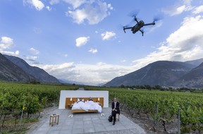 Swiss artists Frank Riklin and his brother Patrik pose with co-founder of the Null-Stern-Hotel (Zero-Star-Hotel) Daniel Charbonnier in the Vineyard suite in Saillon, Switzerland June 15, 2022.