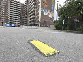 A man was gunned down behind a high-rise apartment on Lawrence Ave. E. and Mossbank Dr. Around 8 p.m. Wednesday night. A huge police marker signifies where he died behind the building at 3847 Lawrence Ave. on Thursday, June 9, 2022. JACK BOLAND/TORONTO SUN