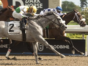 Jockey Rafael Hernandez guides Moira (right) to victory over Pioneer's Edge in the $125,000 Stella Artois Fury Stakes at Woodbine on June 11, 2022. Moira is owned by X-Men Racing LLC, Madaket Stables LLC and SF Racing LLC and coached by Kevin Attard.  (photo MICHAEL BURNS)