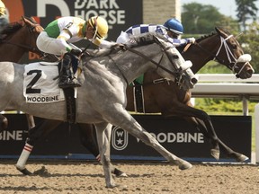 Jockey Rafael Hernandez guides Moira (right) to victory over Pioneer's Edge in the $125,000 Stella Artois Fury Stakes at Woodbine on June 11, 2022. Moira is owned by X-Men Racing LLC, Madaket Stables LLC and SF Racing LLC and coached by Kevin Attard. (photo MICHAEL BURNS)