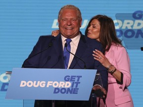 Doug Ford and wife Karla on stage at the Toronto Congress Centre for his victory speech after winning a majority in the provincial election on June 2, 2022.