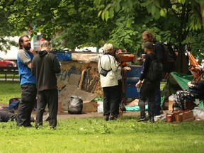 Some of the homeless people who have occupied at tent encampment at Clarence Square Park -- a parkette at the east end of Spadina Ave. at Wellington St. W. -- mill about after residents there were evicted by city officials on Sunday, June 12, 2022.