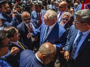 Ontario Premier Doug Ford shakes hands after he is sworn in at the Legislative Assembly of Ontario at Queen’s Park in Toronto, Ont. on Friday, June 24, 2022.