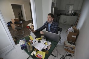 Harrison Browne, who allegedly fell victim to a moving scam that recently led Toronto Police to arrest two men, sits in his empty downtown Toronto apartment on Monday, June 27, 2022.