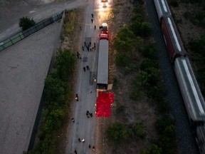 In this aerial view, members of law enforcement investigate a tractor trailer on June 27, 2022 in San Antonio, Texas.