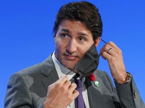 Prime Minister Justin Trudeau removes his face mask for the Global Methane Pledge event during the UN Climate Change Conference in Glasgow, Scotland, U.K., Nov. 2, 2021.