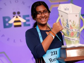 Harini Logan, 14, from San Antonio, Texas, holds the trophy after winning the annual Scripps National Spelling Bee held at National Harbor in Oxon Hill, Md., June 2, 2022.