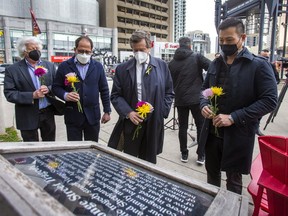 On the fourth anniversary of the deadly Yonge St. van attack, Willowdale MPP Stan Cho (from right), Toronto Mayor John Tory, Willowdale MP Ali Ehsassi and Willowdale  Coun. John Filion prepare to place flowers during a memorial at North York’s Mel Lastman Square on Saturday April 23, 2022.