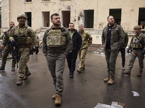 In this photo provided by the Ukrainian Presidential Press Office on Sunday, May 29, 2022, Ukrainian President Volodymyr Zelenskyy walks with his staff as he visits the war-hit Kharkiv region.