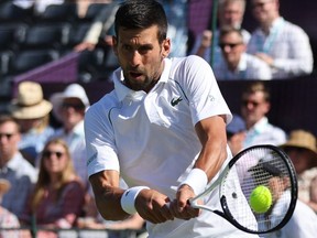 Serbia's Novak Djokovic returns the ball to Canada's Felix Auger-Aliassime during their men's exhibition singles match at The Giorgio Armani Tennis Classic tournament at the Hurlingham Club, in London, on June 22, 2022.