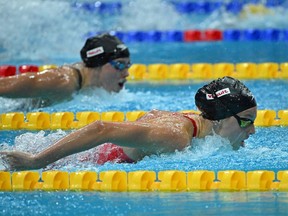 Canada's Summer McIntosh (R) and USA's Hali Flickinger (L) compete in the women's 200m butterfly finals during the Budapest 2022 World Aquatics Championships at Duna Arena in Budapest on June 22, 2022.