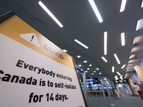 Signage for a COVID-19 screening centre is pictured at Vancouver International Airport in Richmond, B.C. Friday, February 19, 2021.