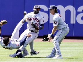 Houston Astros' Yordan Alvarez (44) collides with Jeremy Pena, left, while trying to catch a fly ball hit by New York Mets' Dominic Smith during the eighth inning of a baseball game, Wednesday, June 29, 2022, in New York. Looking on at right is Astros' Jake Meyers.