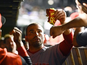Jun 29, 2022; Chicago, Illinois, USA; Cincinnati Reds first baseman Joey Votto (19) celebrates in the dugout after he scored against the Chicago Cubs during the eighth inning at Wrigley Field. Mandatory Credit: Matt Marton-USA TODAY Sports