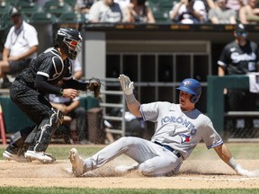 Toronto Blue Jays third baseman Matt Chapman slides safely into home as Chicago White Sox catcher Reese McGuire is unable to tag him out during the fourth inning at Guaranteed Rate Field.