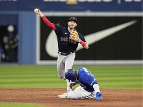 Jun 27, 2022; Toronto, Ontario, CAN; Boston Red Sox second baseman Trevor Story (10) throws to first after getting Toronto Blue Jays right fielder Teoscar Hernandez (37) out at second base during the fifth inning at Rogers Centre.