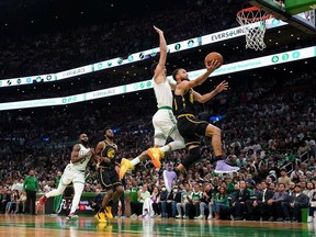 Boston, Massachusetts, USA; Golden State Warriors guard Stephen Curry (30) drives to the net against Boston Celtics forward Jayson Tatum (0) during the first quarter of game four in the 2022 NBA Finals at the TD Garden.