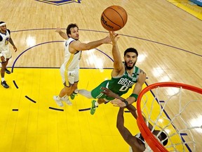 Boston Celtics forward Jayson Tatum (0) shoots the ball against Golden State Warriors forward Draymond Green (23) during game two of the 2022 NBA Finals at Chase Center.