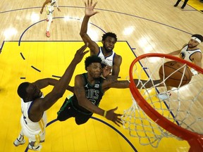 Jun 13, 2022; San Francisco, California, USA; Boston Celtics guard Marcus Smart (36) goes to the basket while defended by Golden State Warriors forward Draymond Green (left) in game five of the 2022 NBA Finals at Chase Center