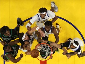 Boston Celtics and Golden State Warriors players battle for a rebound in game five of the 2022 NBA Finals at Chase Center.