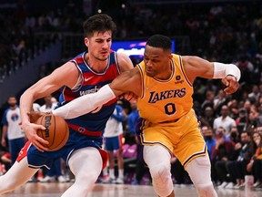 Mar 19, 2022; Washington, District of Columbia, USA;  Los Angeles Lakers guard Russell Westbrook (0) attempts to steal the ball from Washington Wizards forward Deni Avdija (9) during the second half at Capital One Arena.