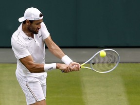 Italy's Matteo Berrettini returns the ball to Spain's Rafael Nadal during their practice on Center Court ahead of the 2022 Wimbledon Championship at the All England Lawn Tennis and Croquet Club, in London, Thursday, June 23, 2022.
