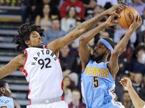 The Toronto Raptors' Lucas Nogueira blocks the Denver Nuggets' Will Barton during their NBA preseason game between at the Scotiabank Saddledome in Calgary on Monday Oct. 3, 2016.