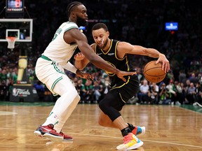 Stephen Curry of the Golden State Warriors dribbles against Jaylen Brown of the Boston Celtics during Game 3 of the NBA Finals at TD Garden on June 8, 2022 in Boston.