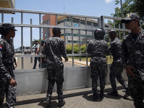 Police are seen outside the Dominican Ministry of Environment building during a shooting, in Santo Domingo, on June 6, 2022.