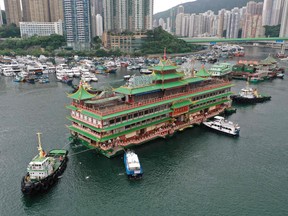In this file photo taken on June 14, 2022 an aerial view of Hong Kong's Jumbo Floating Restaurant, an iconic but ageing tourist attraction designed like a Chinese imperial palace, being towed out of Aberdeen Harbour.
