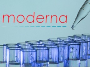 Test tubes are seen in front of a displayed Moderna logo in this illustration taken, May 21, 2021.