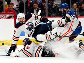 Edmonton Oilers right wing Josh Archibald (15) collides into goaltender Mikko Koskinen (19) after allowing a goal in the second period in game one of the Western Conference Final of the 2022 Stanley Cup Playoffs at Ball Arena.