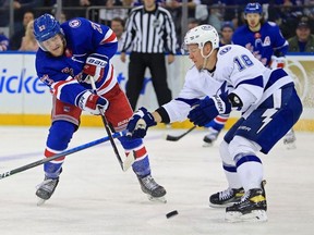 Jun 1, 2022; New York, New York, USA; New York Rangers defenseman Adam Fox (23) passes the puck around Tampa Bay Lightning left wing Ondrej Palat (18) in the third period of game one of the Eastern Conference Final of the 2022 Stanley Cup Playoffs at Madison Square Garden.