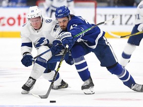 Tampa Bay Lightning forward Ondrej Palat pursues the puck with Toronto Maple Leafs defenseman Timothy Liljegren in the second period at Scotiabank Arena.