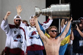 Gabriel Landeskog of the Colorado Avalanche lifts the Stanley Cup on-stage during the Colorado Avalanche Victory Parade and Rally at Civic Center Park on June 30, 2022 in Denver.