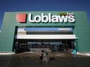 A shopper leaves a Loblaw grocery store in Ottawa.
