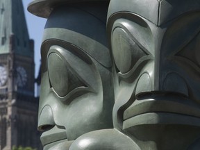 The Three Watchmen statue, created by hereditary chief of the Staast'as Eagle Clan James Hart, is seen near Parliament Hill on Wednesday June 2, 2021.