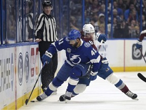 Tampa Bay Lightning left wing Pierre-Edouard Bellemare (41) and Colorado Avalanche right wing Nicolas Aube-Kubel (16) compete for a puck during the first period of Game 3 of the NHL hockey Stanley Cup Finals on Monday, June 20, 2022, in Tampa, Fla.