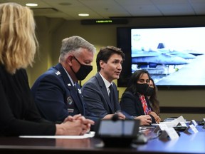 Prime Minister Justin Trudeau, centre, and Minister of National Defence Anita Anand, second right, join US Secretary of Defence Lloyd J. Austin III, not shown, and Gen. Glen VanHerck, second left, Commander of United States Northern Command and North American Aerospace Defense Command, take part in a NORAD briefing in the Battle Cabinet at North American Aerospace Defense Command and United States Northern Command Headquarters in Colorado Springs, Colorado, on Tuesday, June 7, 2022.